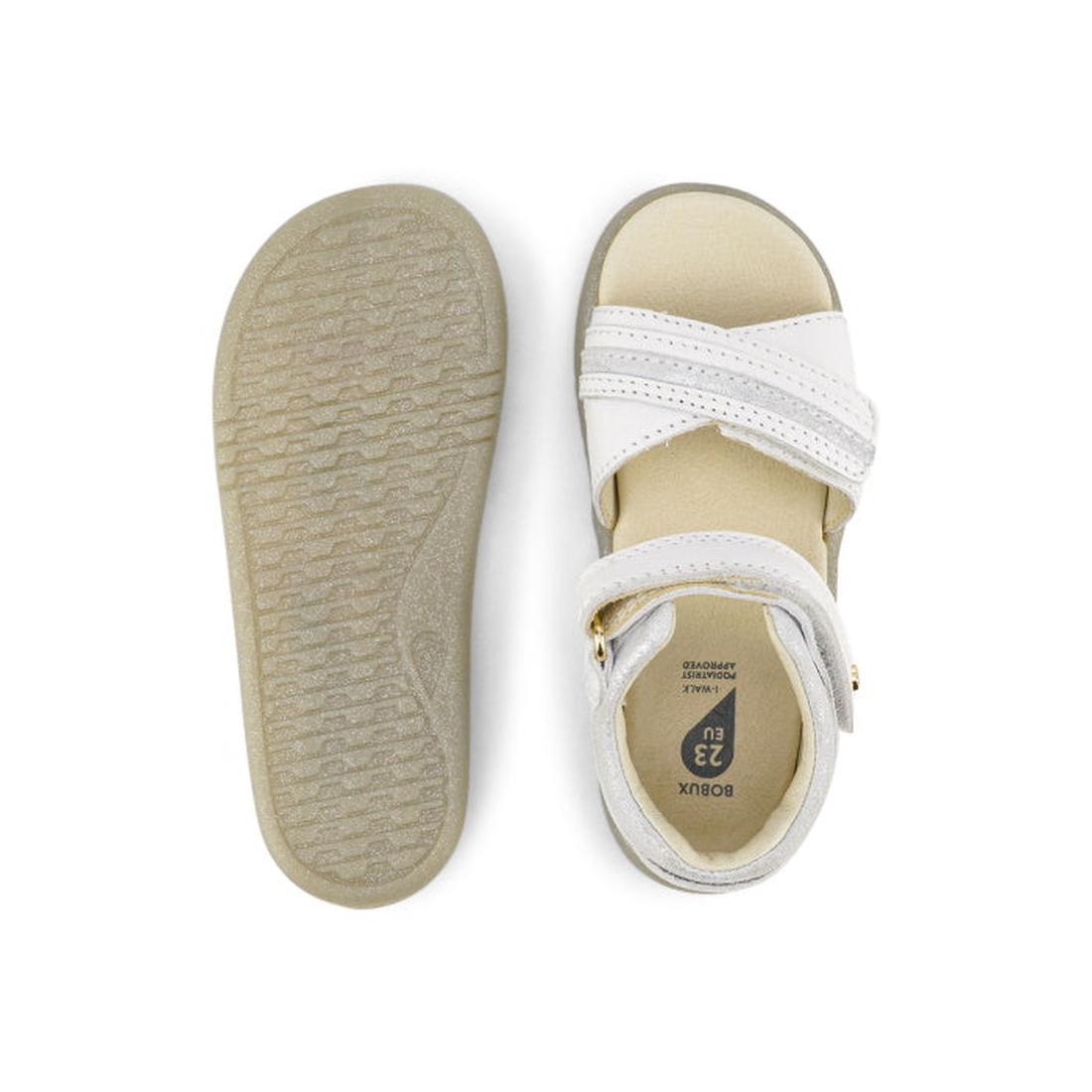 The Bobux iwalk IW Magic Girls Leather Sparkle Sandal in white features a leather upper with two Velcro straps, an open toe design, and a textured sole—perfect as stylish first walker shoes. Shown from above and below., 9420068523081, 9420068523098, 94200
