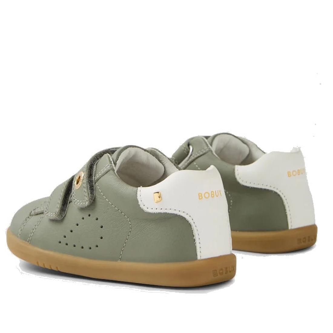 The Bobux IW Iwalk Maverick Leather Sneaker in Vetiver Green features a sage green and white leather design, tan rubber soles, adjustable Velcro straps, perforated detailing for breathability, and gold BOBUX branding on the heel for kids., 9420074836427, 