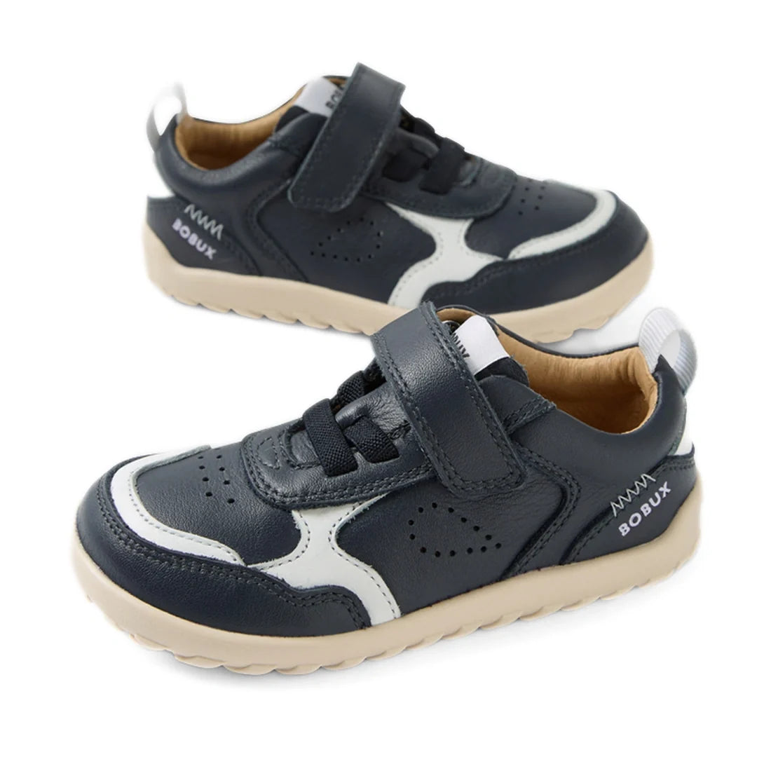 A pair of Bobux IW Iwalk Neo Toddlers Leather Sneakers in navy, featuring a barefoot design, white accents, Velcro straps, light brown zero-drop soles, and perforated detailing is displayed on a white background.