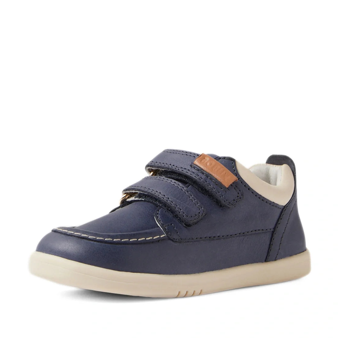 The Bobux IW Iwalk Oakley Toddlers Leather Sneaker in Vintage Blue is a children’s shoe inspired by classic moccasin boat shoe design, featuring two Velcro straps, white stitching details, and a beige lightweight sole, shown from a front-side angle., 9420