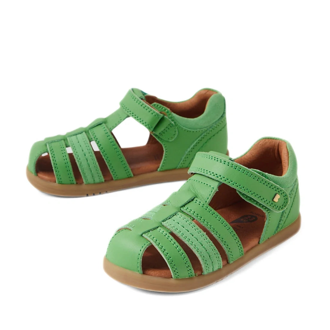 A pair of Bobux IWalk Roam Sandal Retro Green Closed Toe Toddler shoes with tan soles and adjustable Velcro straps, displayed on a white background—perfect summer footwear for kids.
