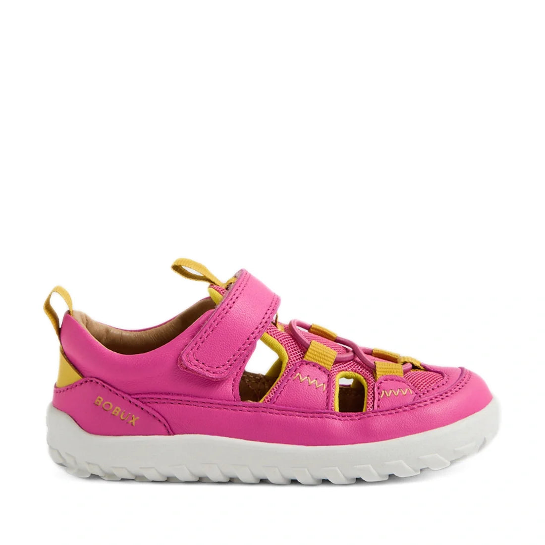 A side view of the Bobux IW Iwalk Rocky Rose Violet Bright Pink Closed Toe Sandal Barefoot—a vibrant pink kids’ leather sandal with yellow accents, a white textured sole, closed toe, and adjustable Velcro strap—displayed on a white background., 9420074863