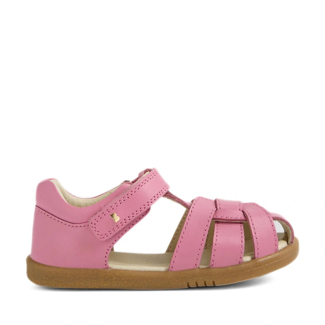 A side view of the Bobux IWalk Skip Twist Sandal in Cashmere Rose Pink for toddlers, featuring a closed heel, open toe, Velcro strap, and a light brown rubber sole, displayed on a white background., 9420074854018, 9420074854025, 9420074854032, 94200748540