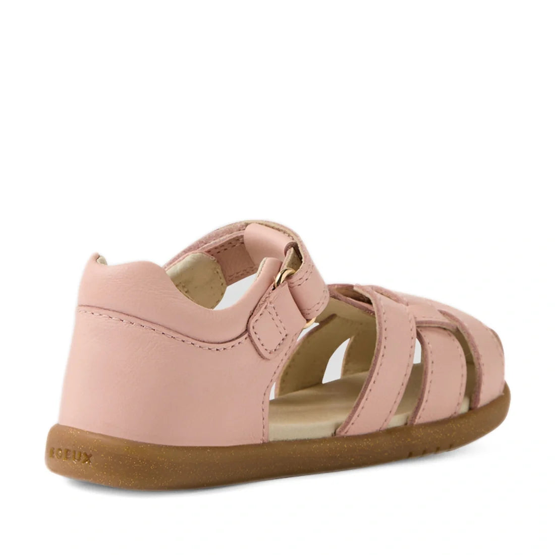 Introducing the Bobux IWalk Skip Twist Sandal in Cameo Rose Pink—a stylish toddler sandal designed with a closed heel, open toe, and an adjustable Velcro strap for a secure fit. Part of our premium leather collection for toddlers, this charming sandal fea