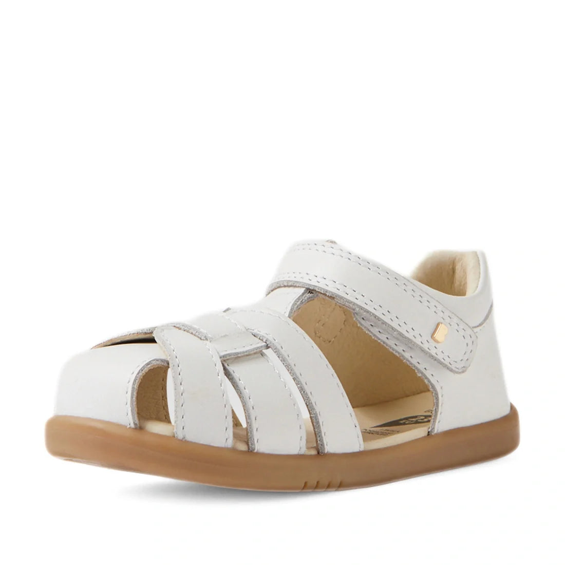 The Bobux IWalk Skip Twist Sandal in White Closed Toe for Toddlers is displayed against a plain white background. Featuring a secure velcro strap, breathable design, and light brown rubber sole, these sandals provide all-day comfort and protection for act