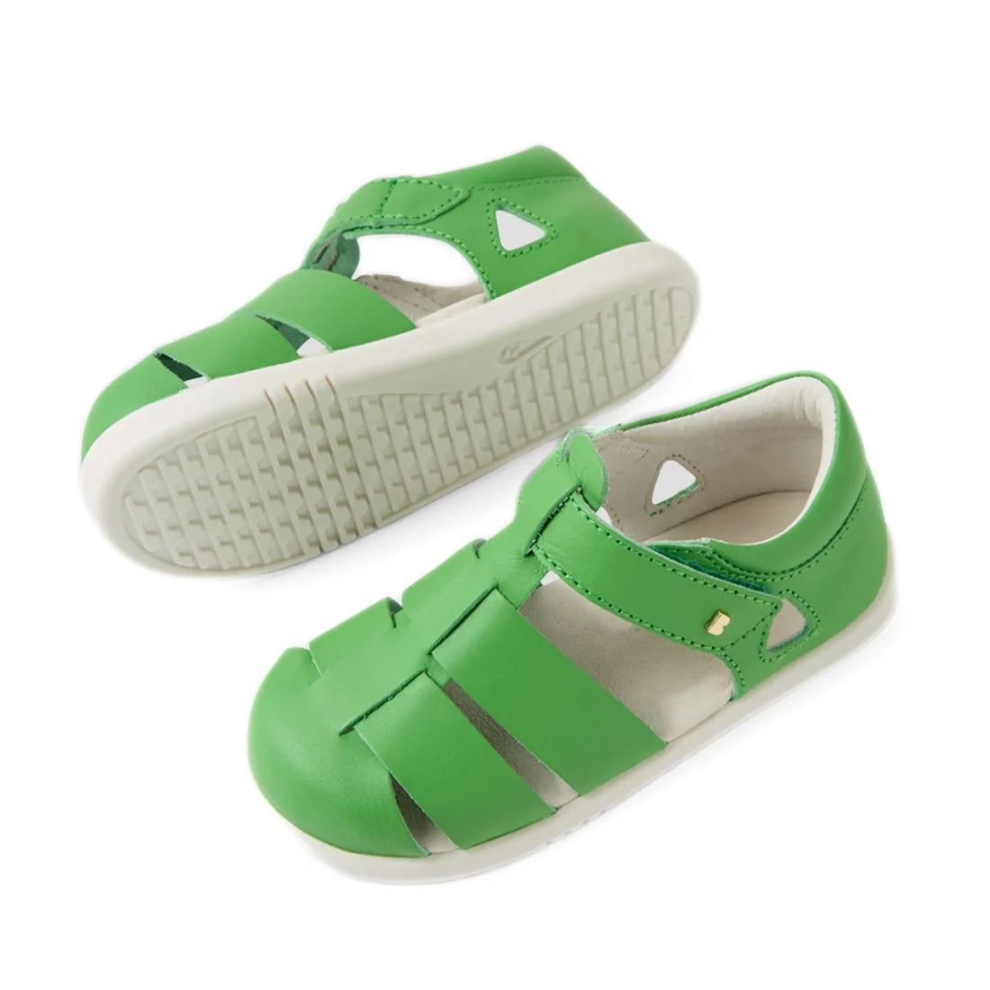 A pair of Bobux IWalk Tidal Sandal Retro Green Closed Toe Toddlers with white soles is displayed from top and side angles on a plain white background. These water-friendly, closed-toe sandals are crafted from premium leather, making them perfect for activ