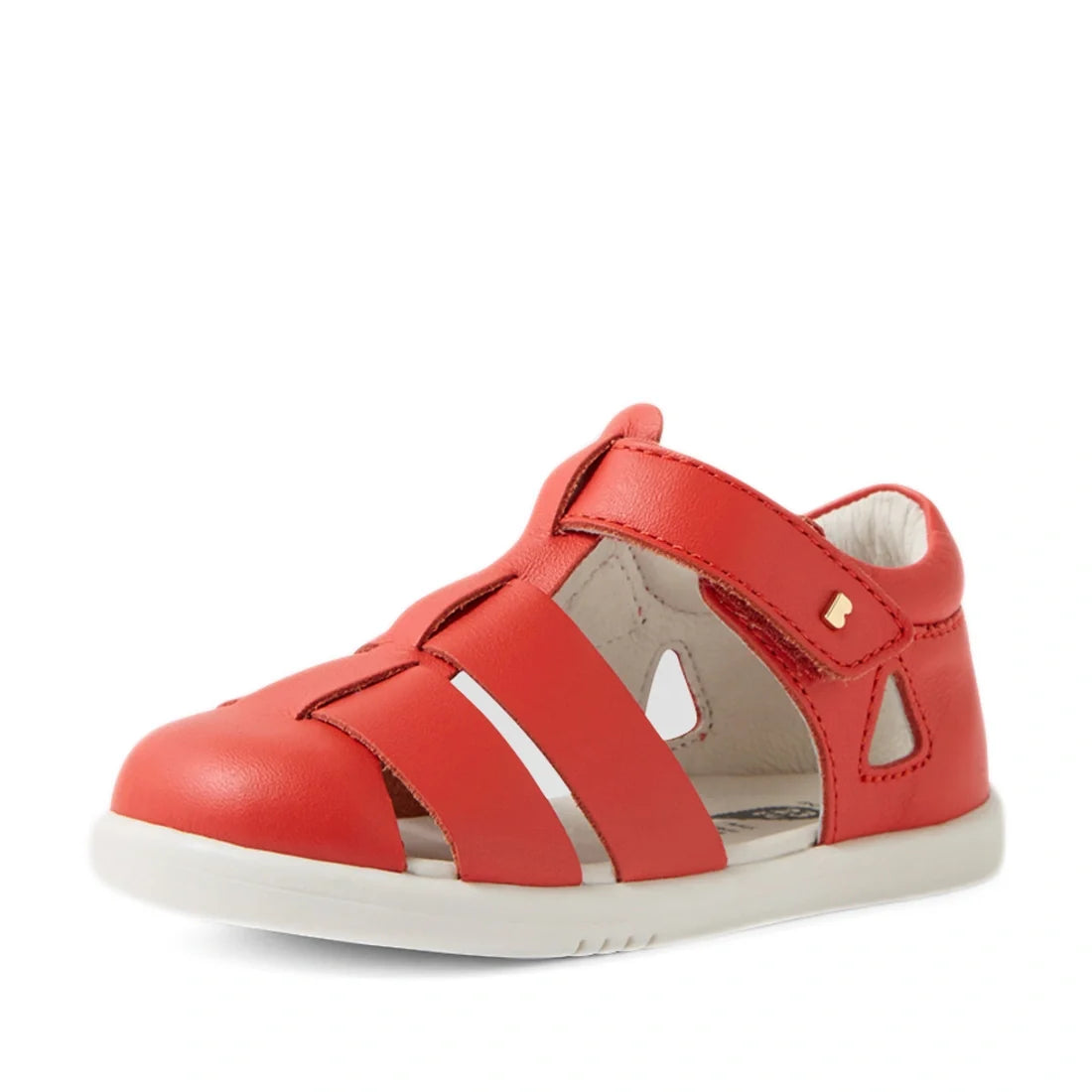 The Bobux IWalk Tidal Sandal in Grenadine Red, designed for toddlers, features a closed toe, white sole, and cut-out details on the sides and top. These water-friendly sandals offer a Velcro strap for easy fastening and include a soft, cushioned interior 