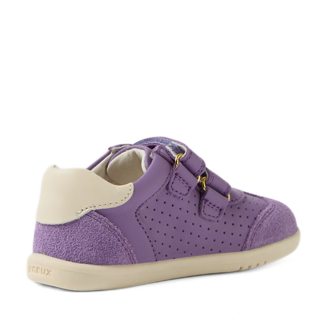 The Bobux IW Iwalk Toddlers Titan Purple Haze Leather Trainer features a children’s purple design with a beige heel and sole, double Velcro adjustable straps, and perforated side details. The slip-resistant sneaker is pictured at an angle to highlight the