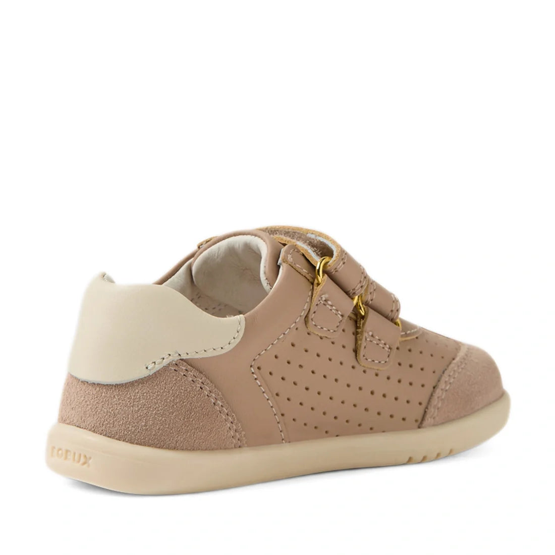 The Bobux IW Iwalk Toddlers Titan Warm Taupe Leather Trainer is a tan and beige leather sneaker for toddlers, featuring perforated sides, suede accents, and two adjustable hook-and-loop straps. Shown angled from the back and side, these slip-resistant sho