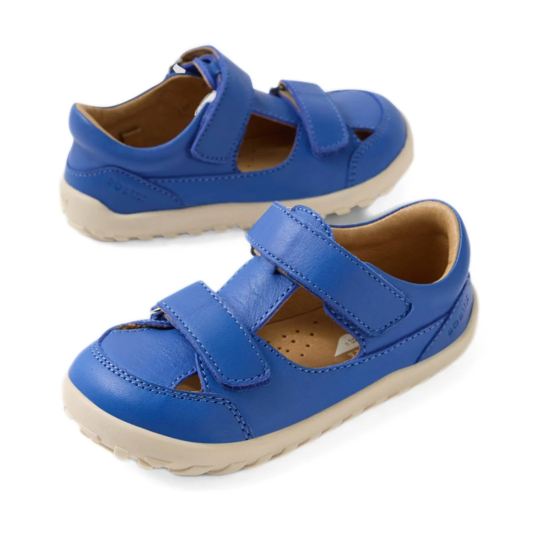 A pair of Bobux IW Iwalk Troop Toddlers Leather Sandal in Dazzling Blue, featuring a barefoot design with beige soles, Velcro straps, and closed toes, displayed on a white background.