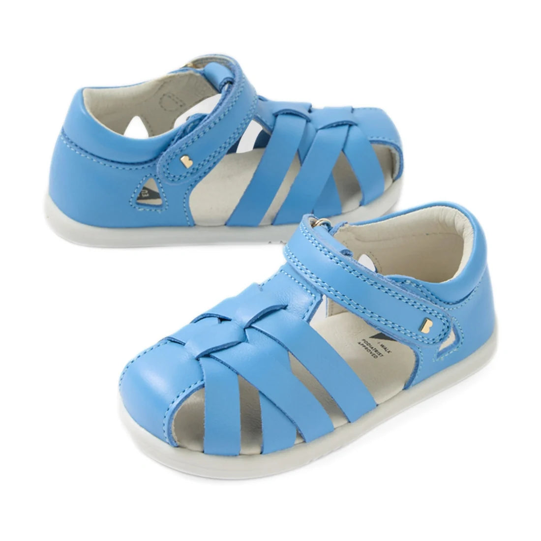A pair of Bobux Iwalk IW Tropicana II Baltic Sea Blue leather sandals for toddlers, featuring closed-toe protection, white soles, and Velcro straps, displayed on a white background.