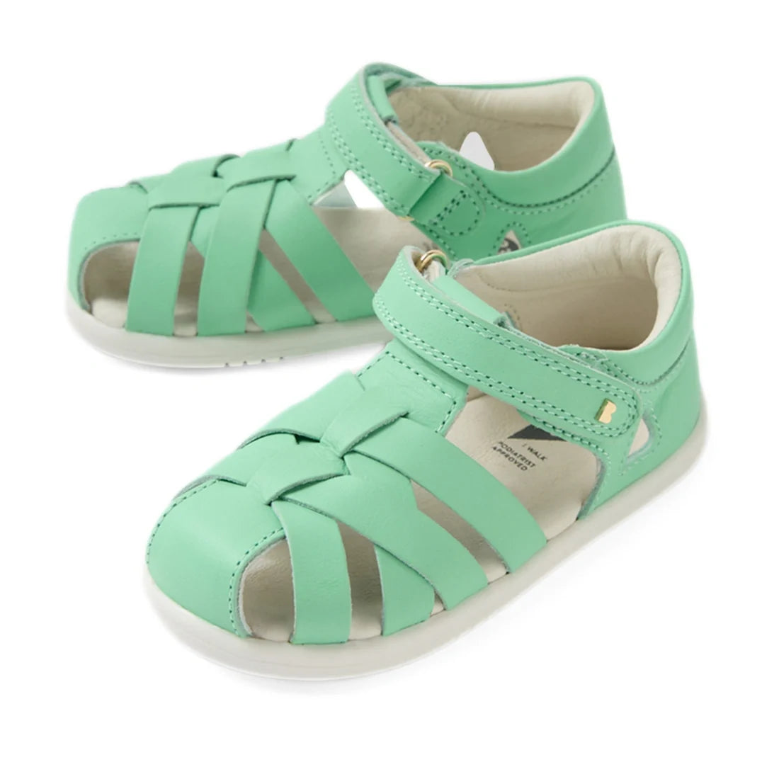 A pair of Bobux Iwalk IW Tropicana II Jelly Mint Green Leather Sandals for toddlers, featuring a woven design, closed toes, open sides, and convenient hook-and-loop ankle straps.