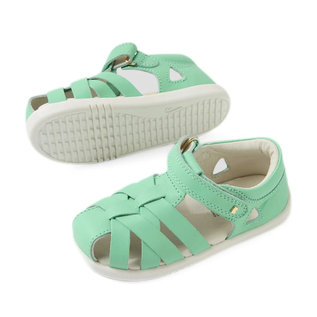 A pair of mint green, strappy closed-toe sandals for children—identified as the Bobux Iwalk IW Tropicana II Jelly Mint Green Leather Sandal—are displayed on a white background. One sandal stands upright while the other rests on its side to reveal the text