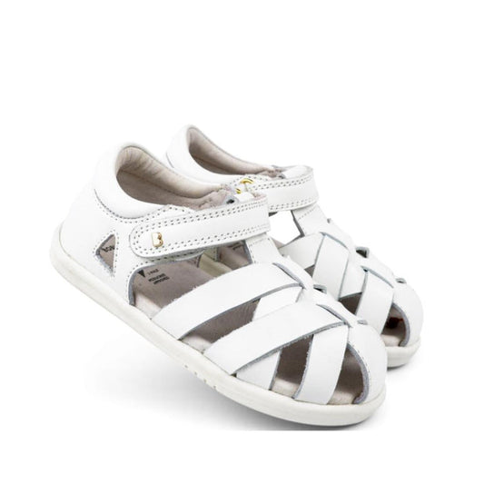 The Bobux Iwalk IW Tropicana II Sandal 638307 White is a children's sandal with closed toes, open sides, Velcro ankle straps, woven quick dry leather, and a flat rubber sole.