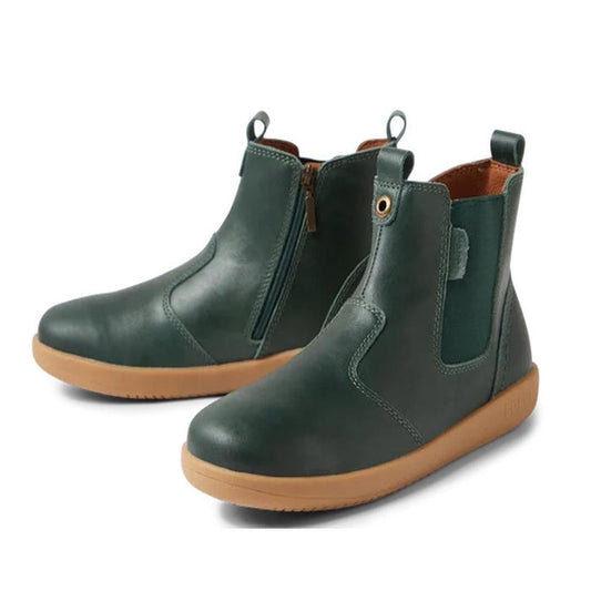 The Bobux Kid+ Jodphur Leather Boot in Rainforest Green is a unisex ankle boot featuring side zippers, elastic panels, pull tabs, and light brown rubber soles, shown against a white background.