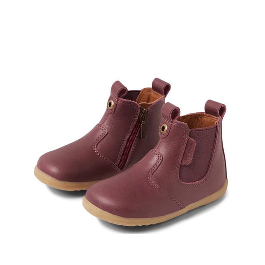 The Bobux Step Up Jodhpur Boot Fig Purple 732968 is a unisex kid's boot-style ankle shoe with tan soles, side zippers, elastic panels, and pull tabs—perfect first leather walkers, shown on a white background.