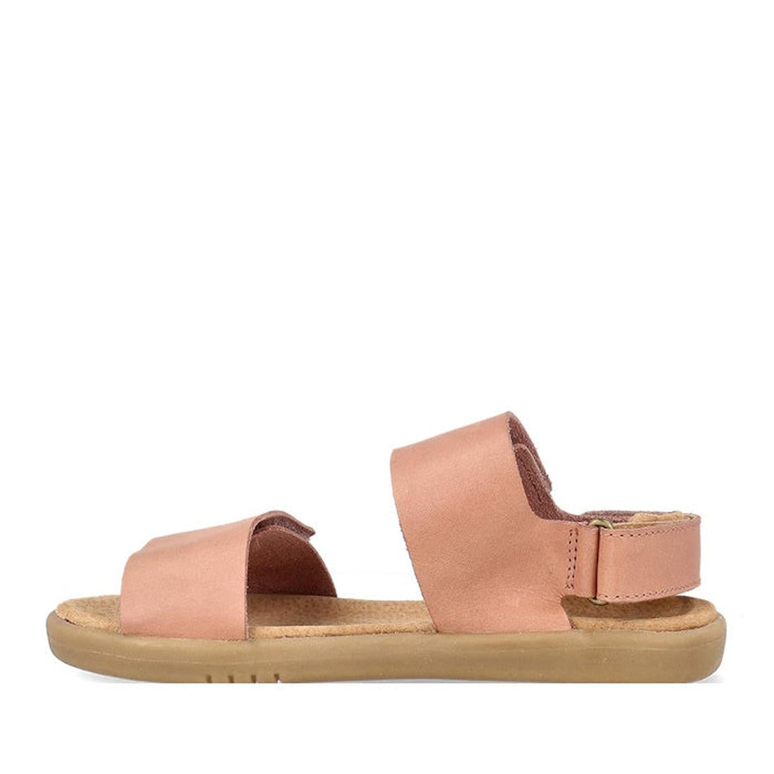 The Bobux Kid+ Plus Italian Clay Coast Open Toe Sandal 851201 is a tan, breathable sandal with a flat sole, wide front strap, open toe, and matching Velcro ankle strap, shown on a white background., 9420075767065, 9420075766723, 9420075768215, 94200757675