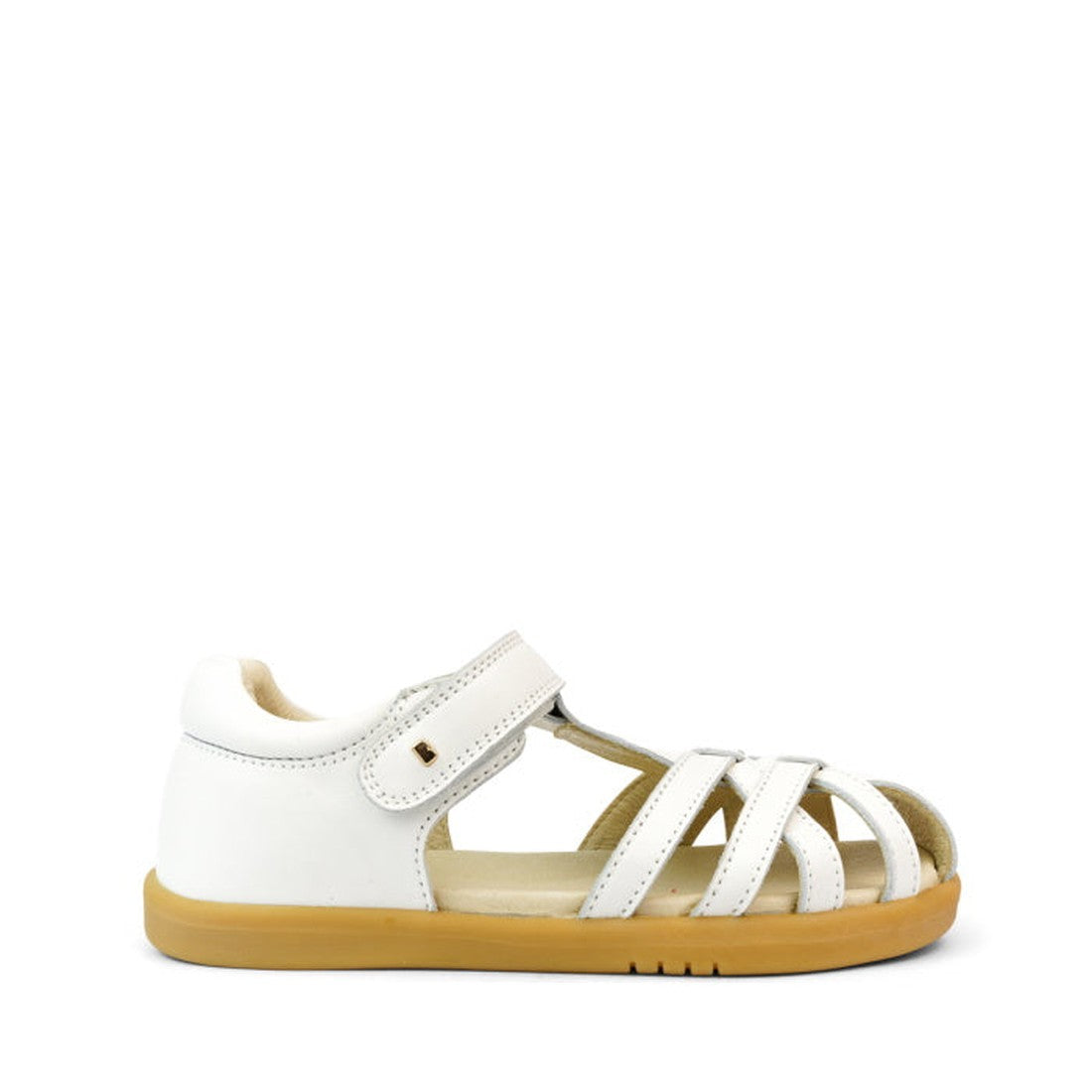 The Bobux Kids + Plus Girls Cross Jump White Leather Sandal 837006 features a white leather upper with multiple straps, closed heel, open toe, tan rubber sole, and Velcro ankle strap. Displayed on a white background., 9420068507159, 9420068507166, 9420068
