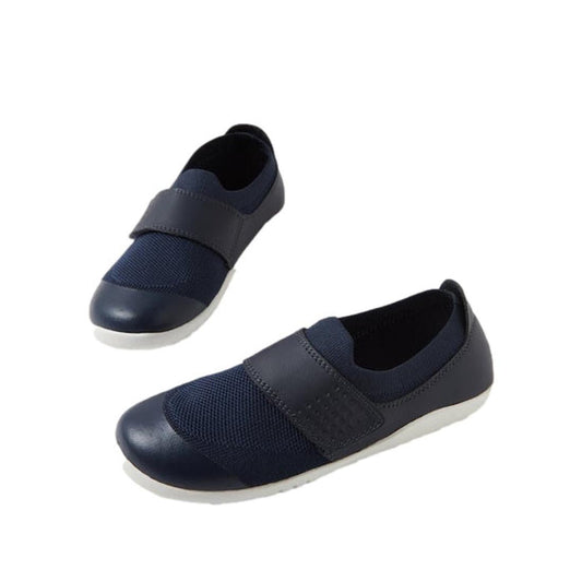 The Bobux Kid+ Lo Dimension III Navy 838610 CLEARANCE shoes are kids’ navy blue performance footwear with mesh fabric, a wide velcro strap, and white rubber soles, shown on a white background.