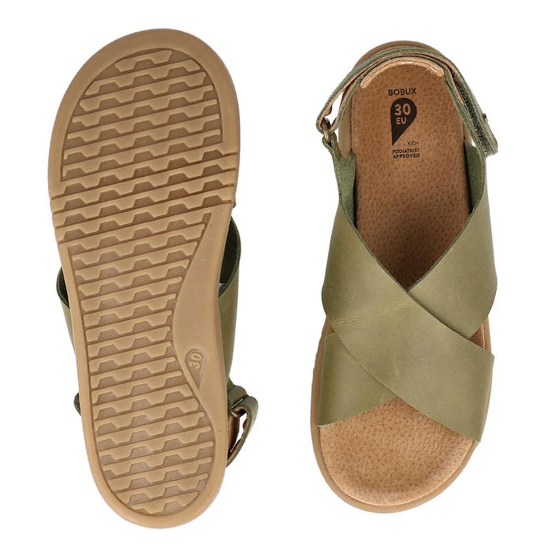 Two views of the Bobux Kid+ Plus Glide Sea Kelp Green Open Toe Sandal 851103, size 30 EU: the left shoe reveals a textured tan sole, while the right displays olive green crisscross straps, an open toe design, and a tan footbed., 9420075773554, 94200757762