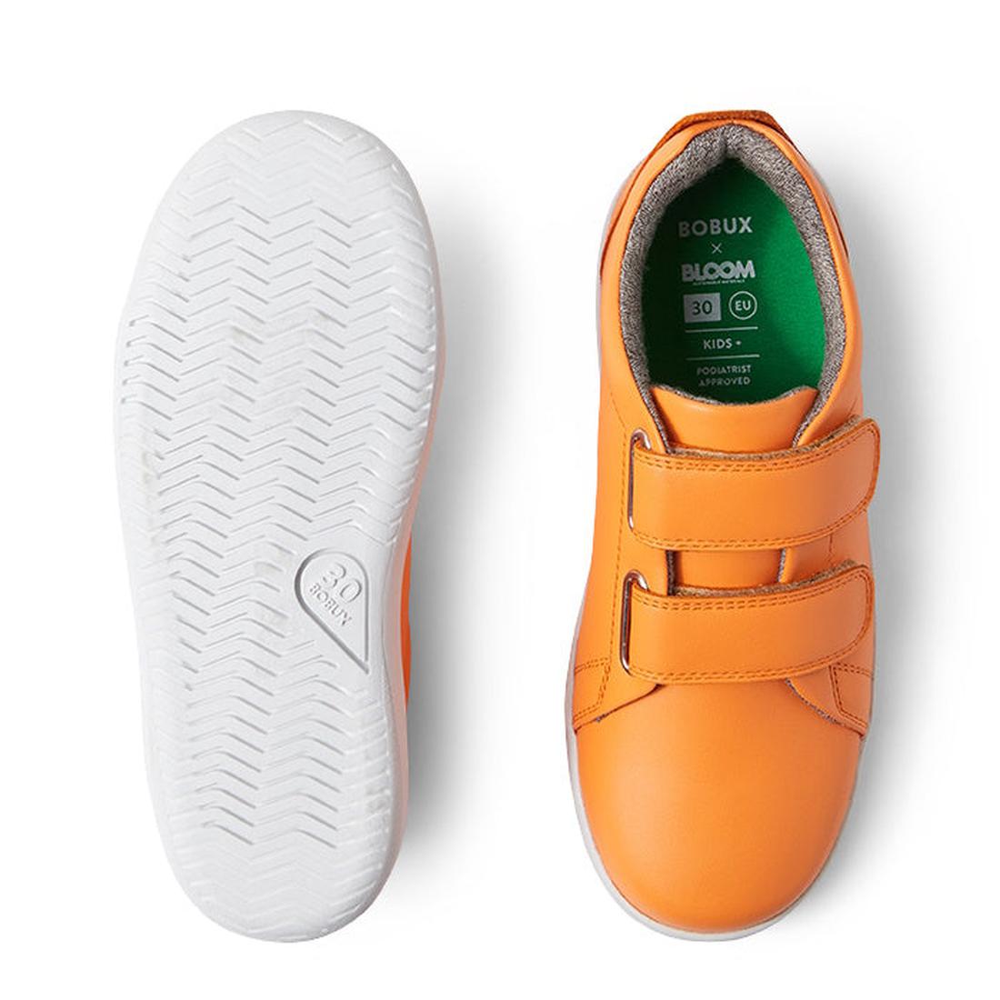 The Bobux KP Kid Plus Grass Court Apricot Crush 841009 kids trainers feature an orange leather upper and double Velcro straps; one shoe is shown top-down, the other displays a white herringbone-patterned sole., 9420075776265, 9420075777644, 9420075772717,
