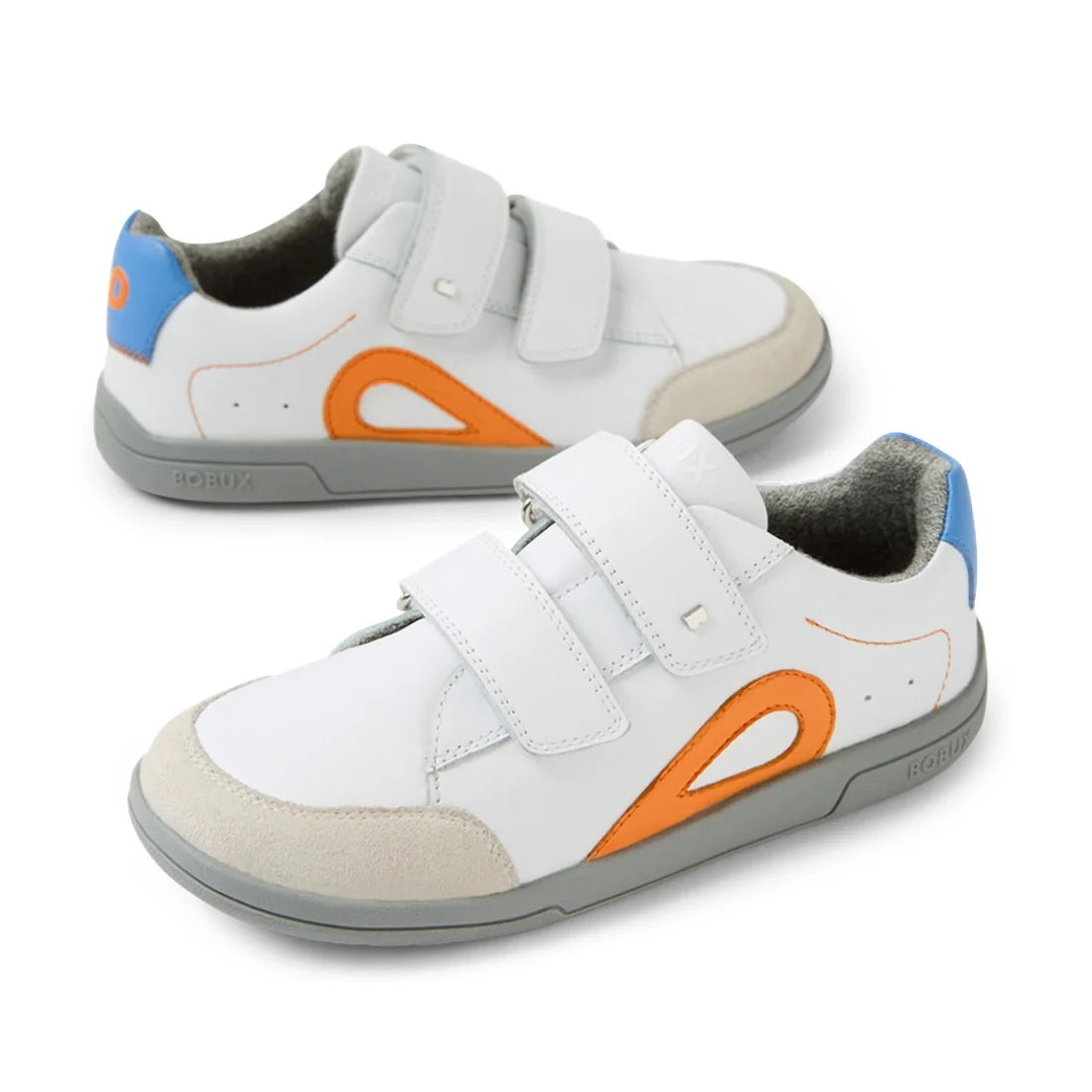 Introducing the Bobux KP Kids Plus Blaze Leather Sneaker in White Orange: these children’s sneakers feature premium white leather with vibrant orange and blue accents, gray soles, beige toe caps, and two velcro straps for easy fastening. Designed with a c