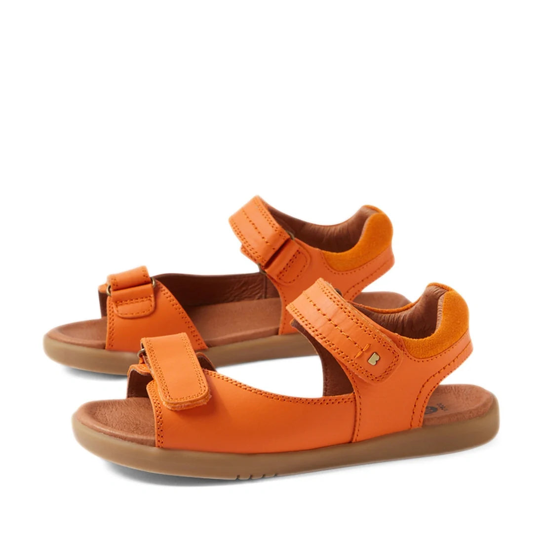 The Bobux KP Kids Plus Driftwood Leather Sandal in Orange Peel is a pair of boys’ leather sandals inspired by the classic Driftwood style, featuring bright orange open-toe design, adjustable Velcro straps, and brown cushioned soles for comfort, displayed 