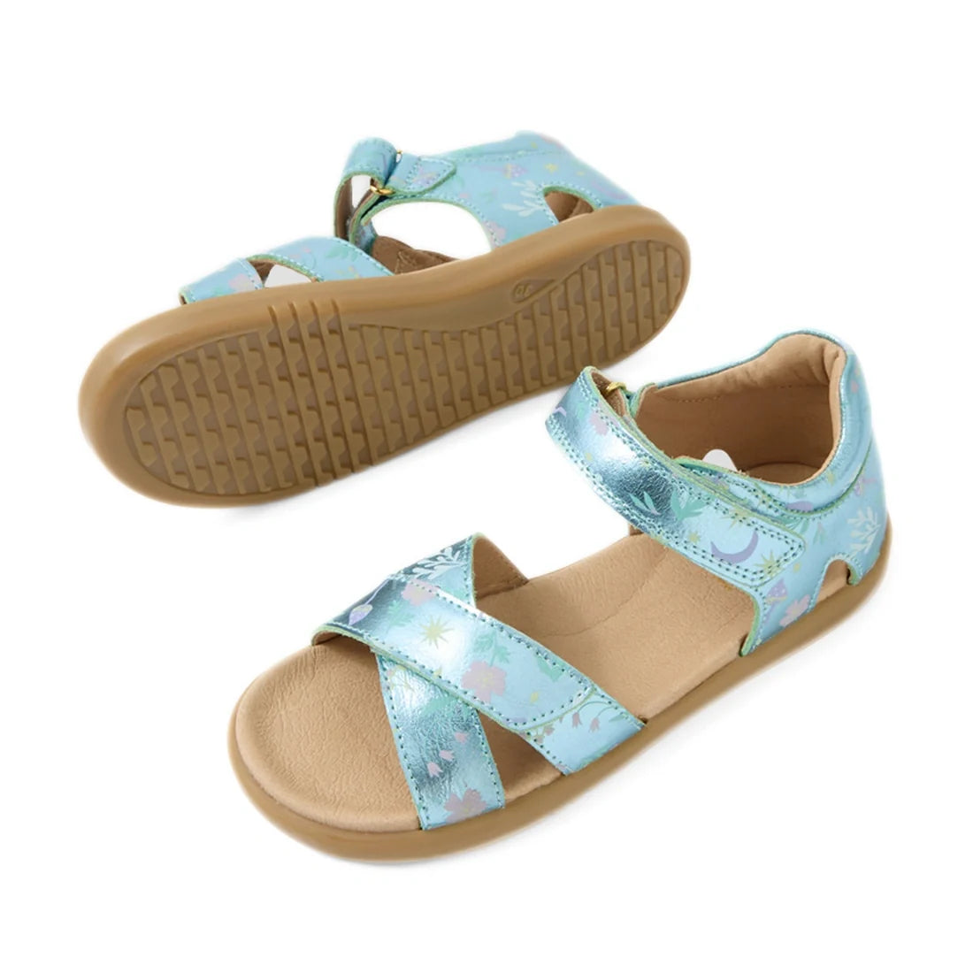 Bobux KP Kids Plus Flora Leather Sandal Jelly Mint Metallic Blue features charming open-toe sandals for children, designed with light blue metallic leather straps, delightful floral patterns, and tan non-slip rubber soles. One sandal stands upright while 