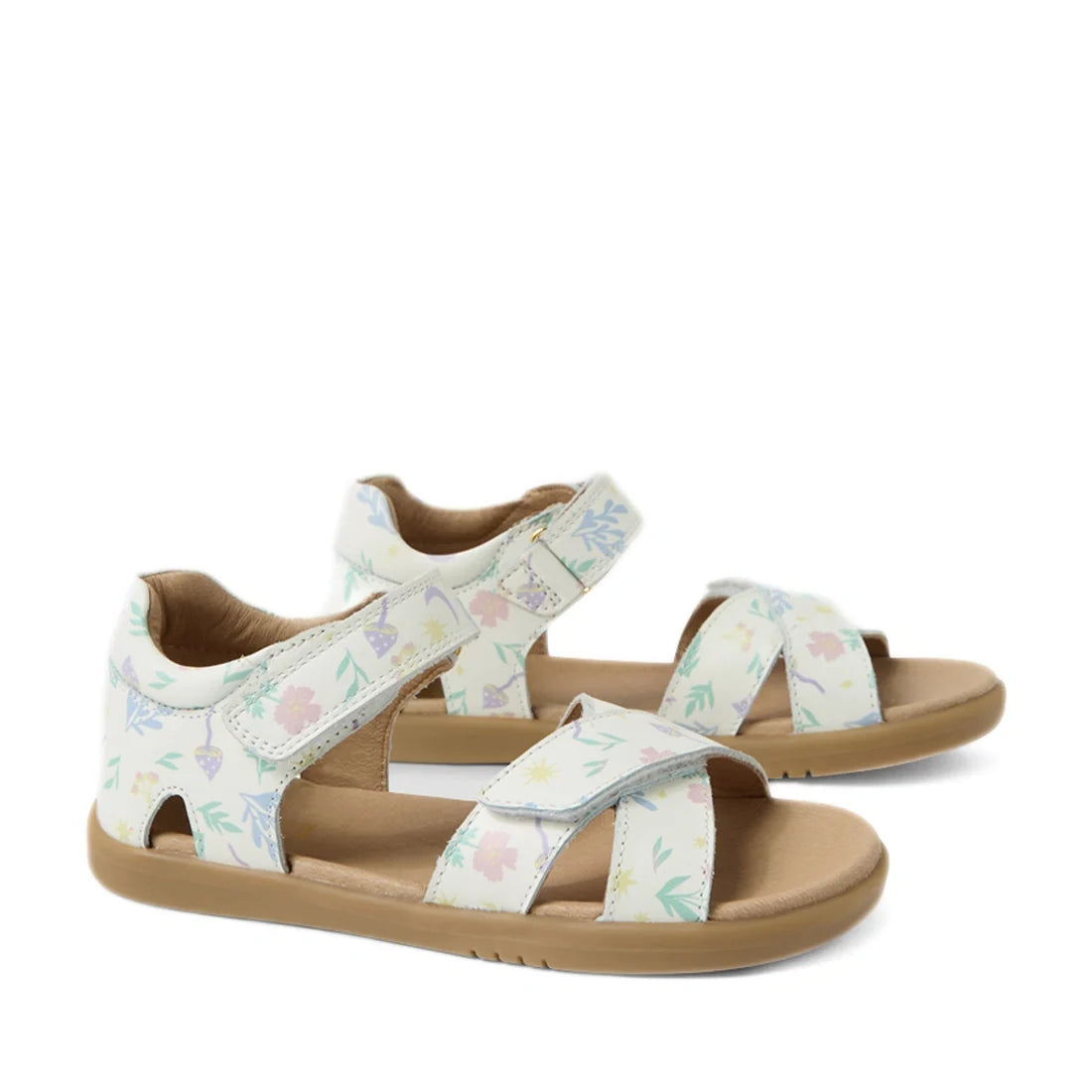 The Bobux KP Kids Plus Flora Leather Sandal in White Floral features two adjustable leather straps with a pastel flower print and a tan sole, combining comfort and charming floral style for kids. Displayed on a white background.