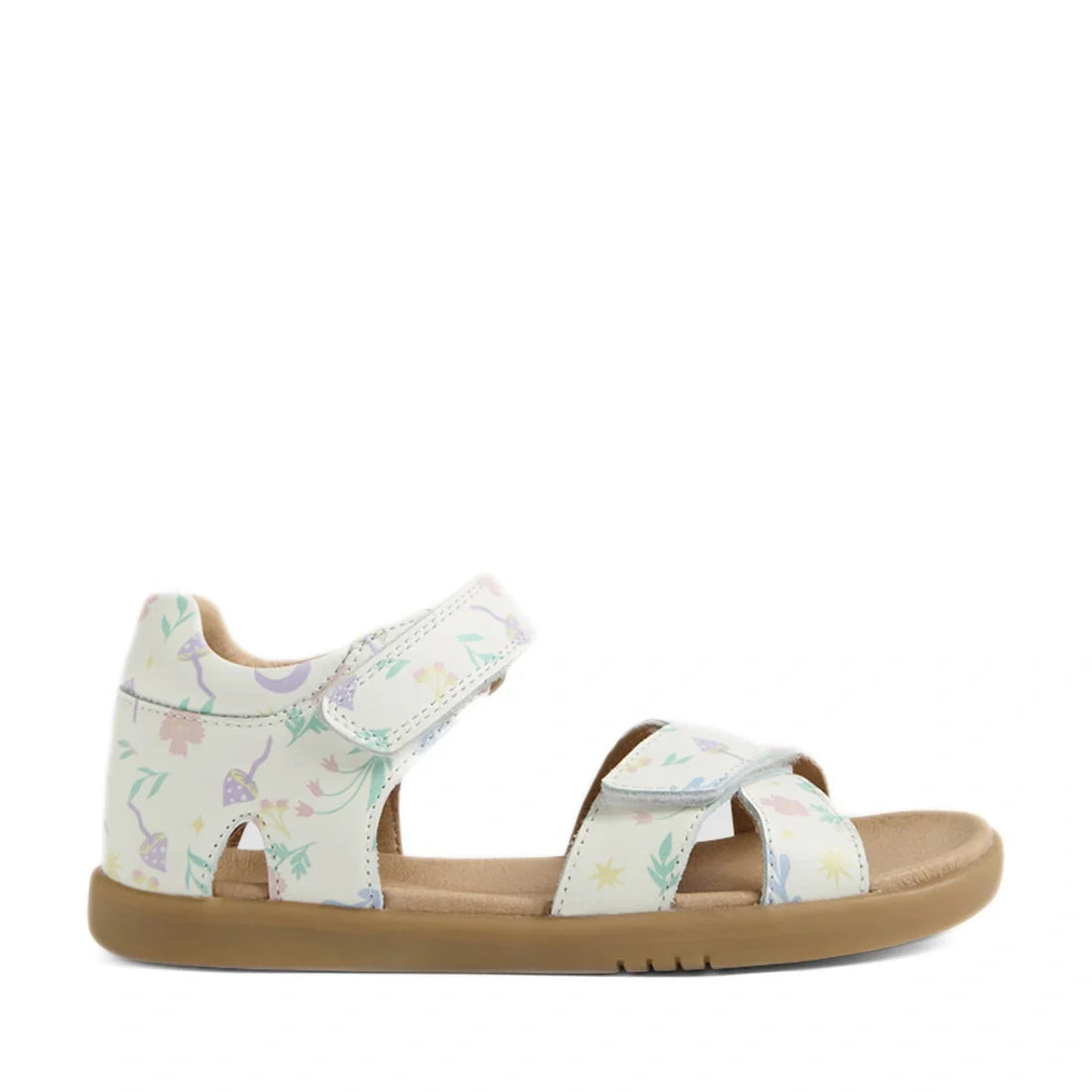 The Bobux KP Kids Plus Flora Leather Sandal White Floral features a tan sole and white leather straps adorned with pastel-colored nature-inspired prints, including leaves, mushrooms, stars, and delicate floral accents. Designed for comfort, these adjustab
