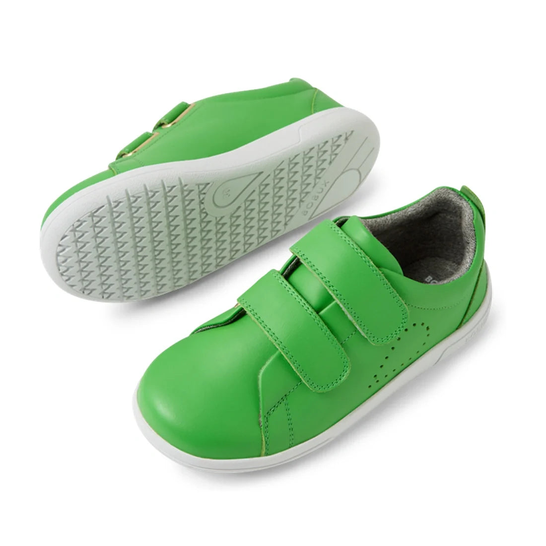 A pair of Bobux KP Kids Plus Grass Court 2 II Leather Sneaker Retro Green, featuring a vibrant green leather upper, white soles, and two hook-and-loop strap closures; displayed from the side and bottom views. Designed with a wide fit to ensure all-day com