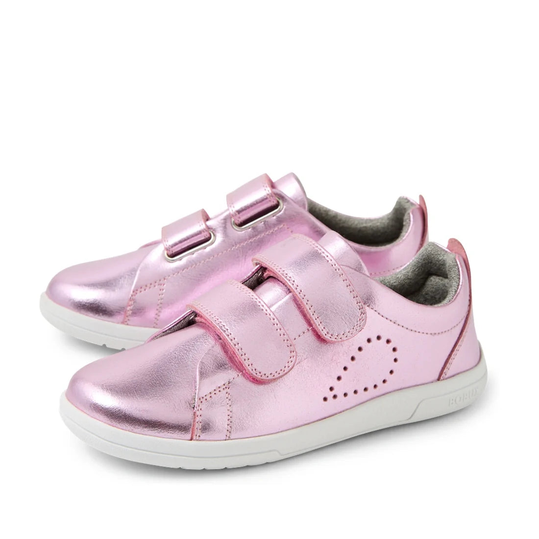 The Bobux KP Kids Plus Grass Court 2 II Leather Sneaker in Pink Metallic, featuring a shiny metallic pink leather upper, two Velcro straps, and white soles, is displayed on a white background. Inspired by the iconic Bobux Grass Court design, one sneaker i