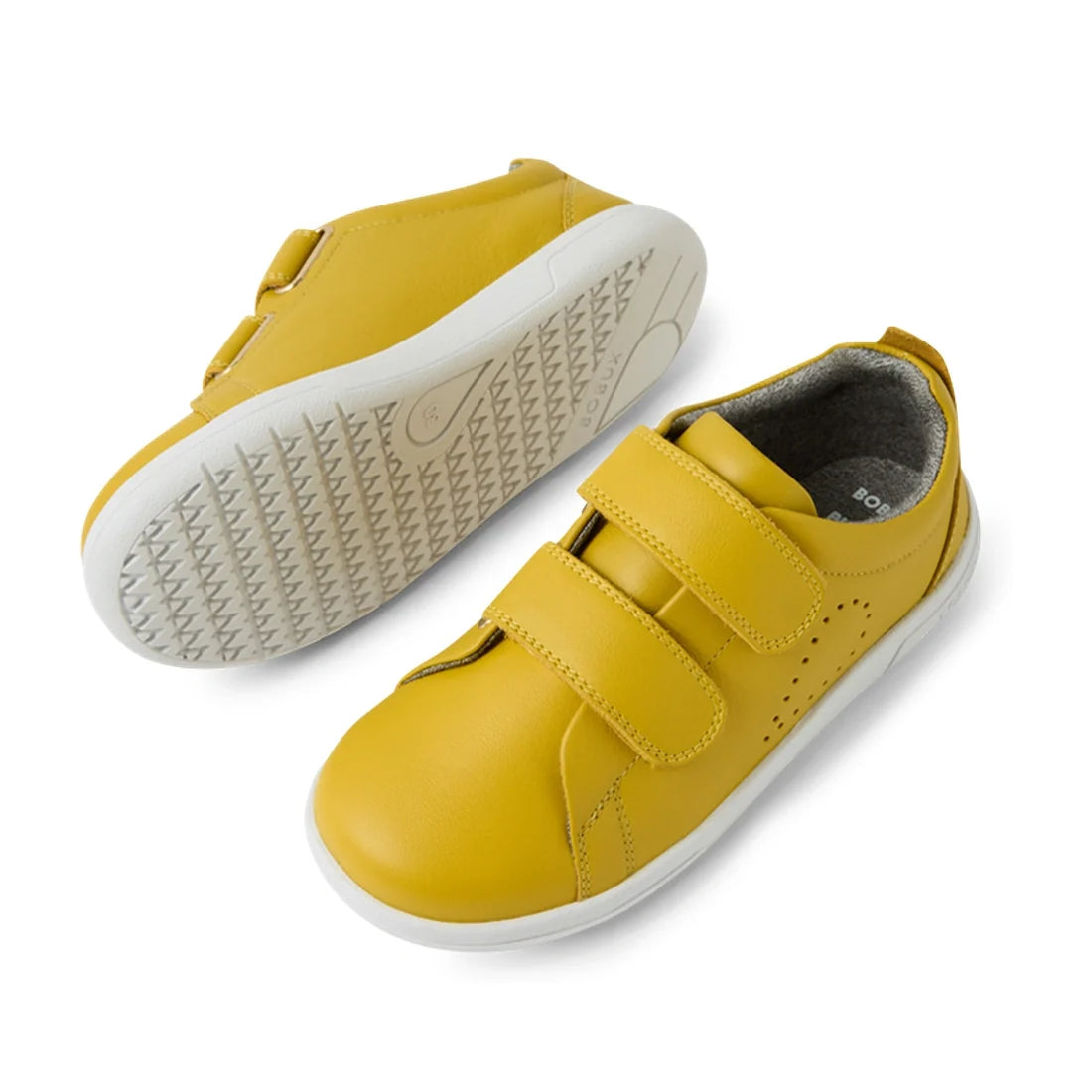 A pair of Bobux KP Kids Plus Grass Court 2 II Leather Sneakers in Mango Mint leather, featuring white soles and two Velcro straps, is shown from a side view and sole view on a white background. Designed for a wide fit, these stylish sneakers are perfect f