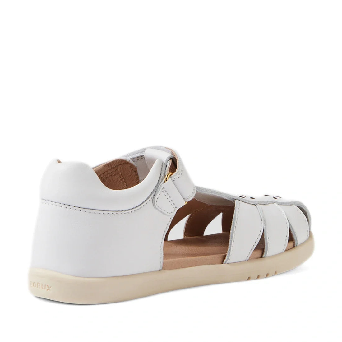 The Bobux Kid+ Plus KP Holly White Closed Toe Sandal is a white children’s sandal featuring a closed heel, open sides, Velcro strap, and beige sole—evoking the style of classic leather sandals for girls—depicted from a rear angle against a plain white bac