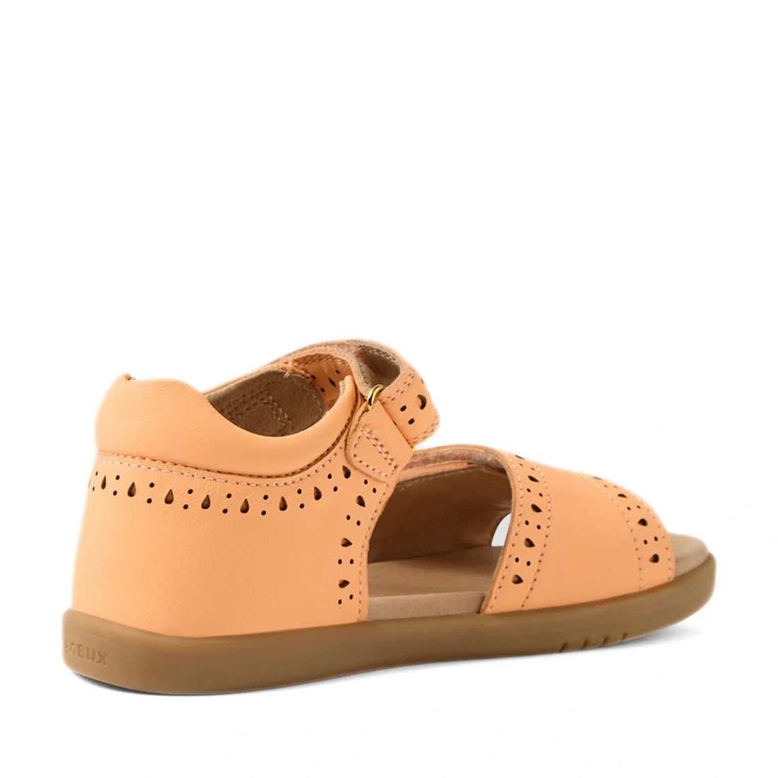 Bobux Kid+ Plus KP Logan Peach Jelly Open Toe Sandal for kids, featuring a peach-colored design with cutout details, closed heel, open toe, adjustable velcro strap, and a flat tan rubber sole, displayed at an angle on a white background., 9420074847201, 9