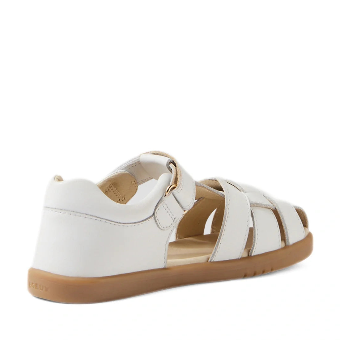 The Bobux Kids Plus KP Skip Twist White Closed Toe Sandal is a stylish kids’ sandal crafted from white leather, featuring a closed heel, open toe, and crisscross straps. Shown from the back angle, it boasts a light brown sole and an easy-to-use hook-and-l