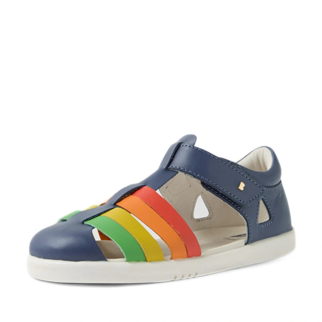 The Bobux Kid + Plus Tidal Closed Toe Quick Dry Sandal in Vintage Indigo Blue is a children’s sandal featuring cutouts and vibrant rainbow-colored straps (red, orange, yellow, green) on the side, paired with a white sole. Crafted from water-friendly leath