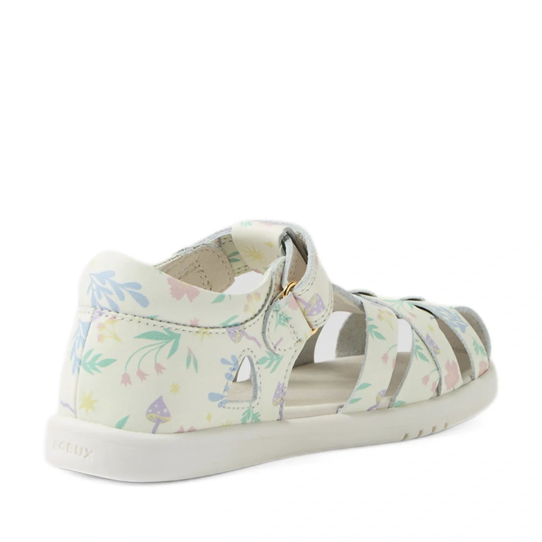 A white leather kids’ sandal called the Bobux Kids Plus KP Tropicana II White Floral Quick Dry Sandal, featuring pastel floral and mushroom patterns, a closed heel, and open toe straps—shown at an angle from the back and side—captures the charming style o