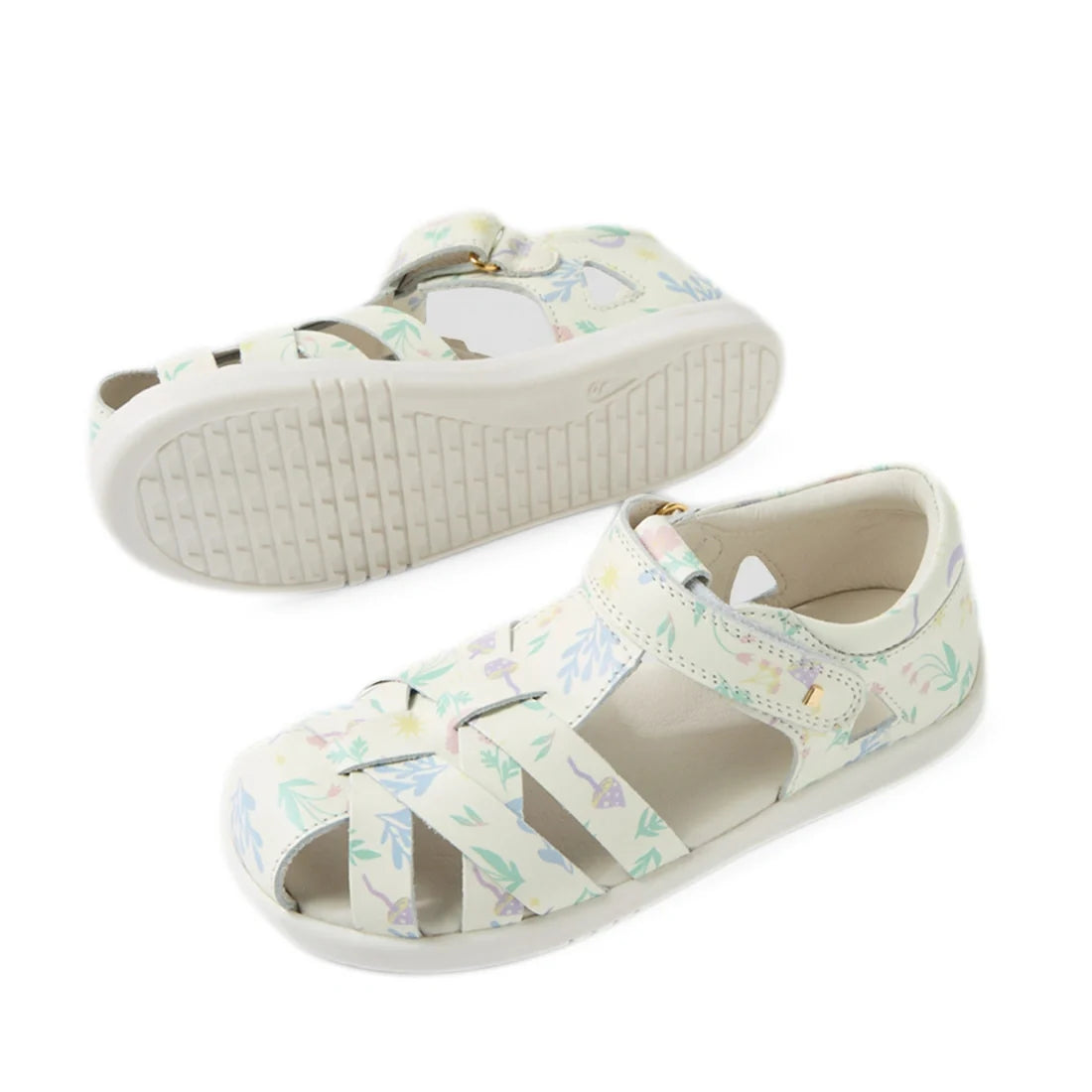 Bobux Kids Plus KP Tropicana II White Floral Quick Dry Sandal features a children's white sandal design with pastel floral patterns, a closed toe, and an adjustable Velcro strap. Crafted from premium leather for durability and comfort, one sandal is shown