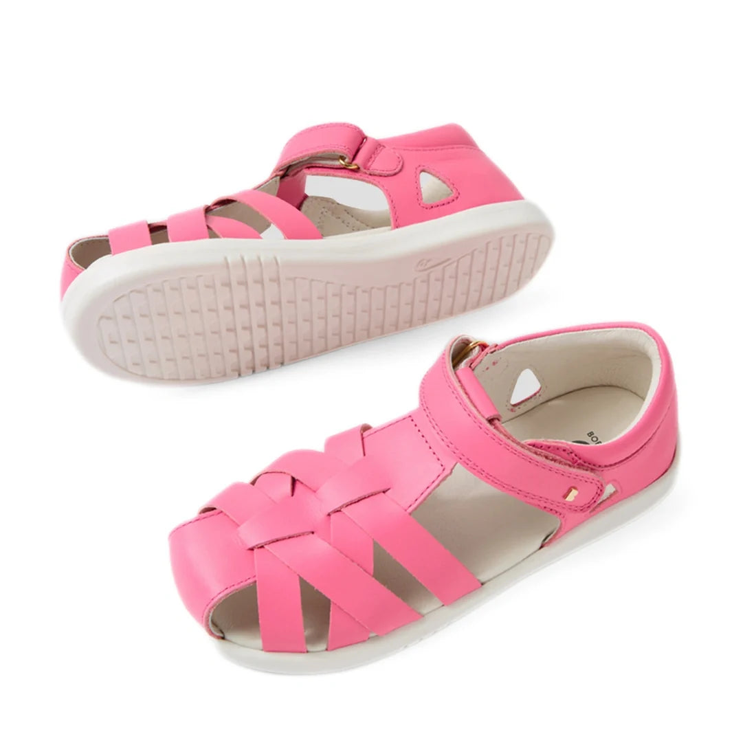 Two pink Bobux Kids Plus KP Tropicana II Pink Lemonade Quick Dry Sandals for children, featuring closed toes, woven straps, white soles, and a hook-and-loop strap. Perfect as kids’ summer shoes, these sandals combine style and comfort. One sandal is shown