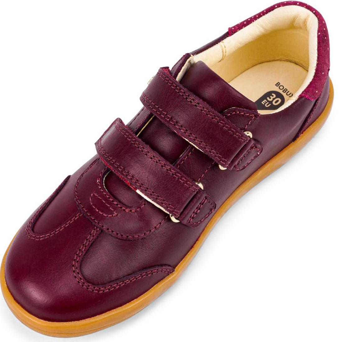 The Bobux Kids Plus KP Sprite Sneaker in Boysenberry is a unisex maroon children’s shoe with two velcro straps, tan rubber sole, and cushioned beige interior, angled to display the top and side., 29968, 9420071316663, 9420071316670, 9420071316687, 9420071