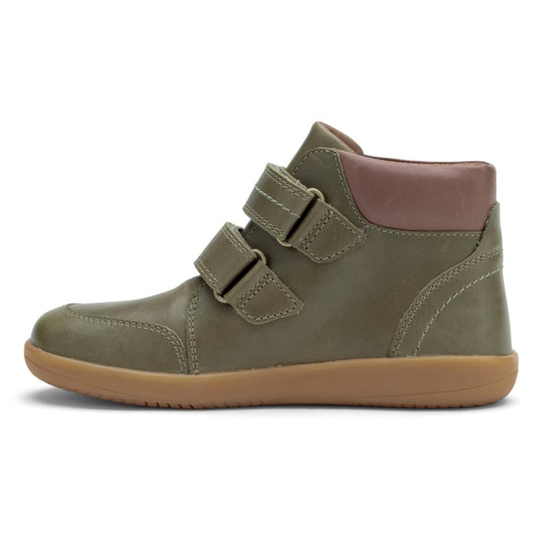 A side view of the Bobux Kid+ Timber Boot Olive 832909F, a high-top in olive green with a tan rubber sole, two adjustable velcro straps, and a padded light brown ankle collar for added comfort., 9420071304523, 9420071304530, 9420071304547, 9420071304554, 
