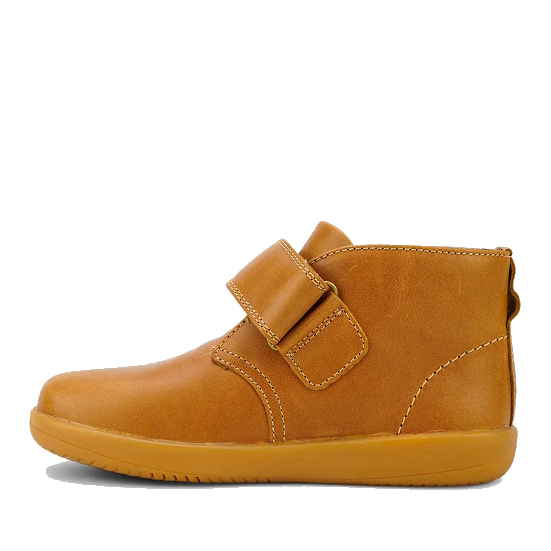 The Bobux Kid+ Desert Boot Caramel 830305Z inner foot view is a brown leather unisex children’s high-top boot with a tan rubber sole and wide hook-and-loop strap, shown in side profile against a white background., 9420068516861, 9420075719682, 94200757196
