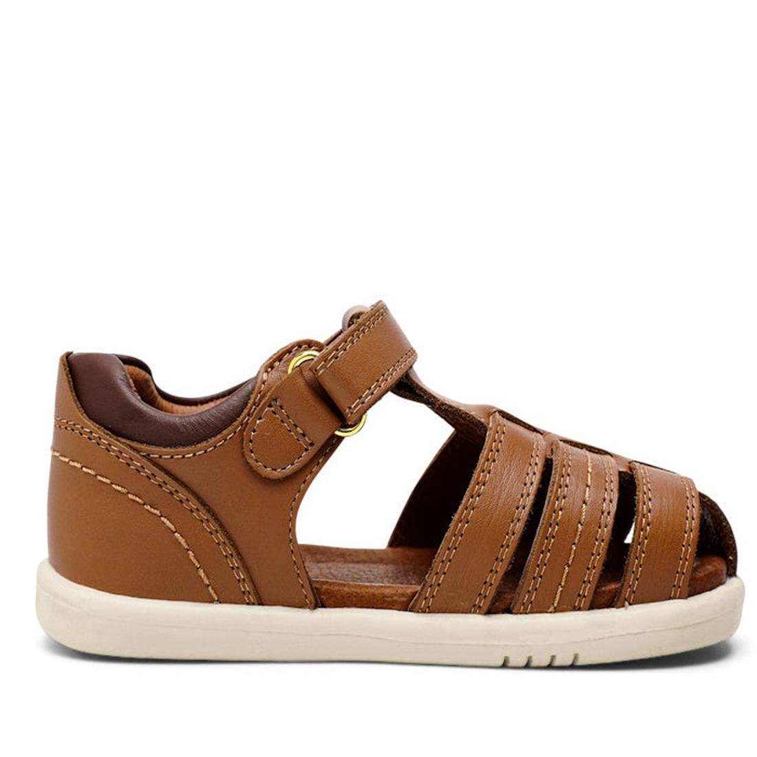 The Bobux IWalk Roam Sandal in Caramel/Toffee leather is a kids' summer sandal with a closed heel, open toe, front straps, a hook-and-loop strap with gold buckle, and a flat off-white rubber sole., 9420071319169, 9420071319176, 9420071319183, 942007131919