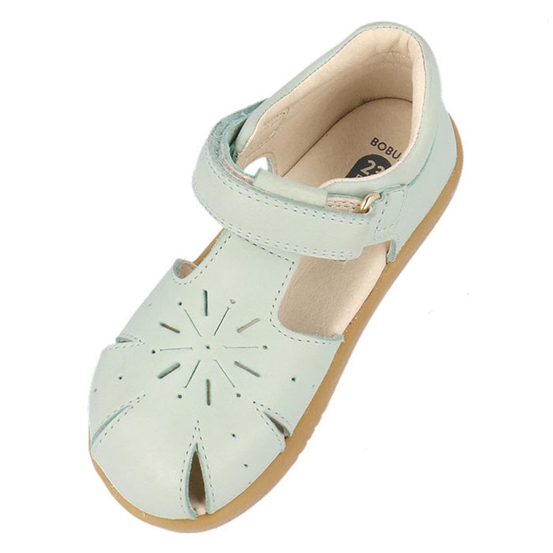 The Bobux Iwalk IW Compass Kids Mist Blue Leather Sandal 641205 features light blue leather, a tan sole, closed toe, front cutouts, and an adjustable hook-and-loop ankle strap—perfect summer sandals for little ones., 9420075708464, 9420075708471, 94200757
