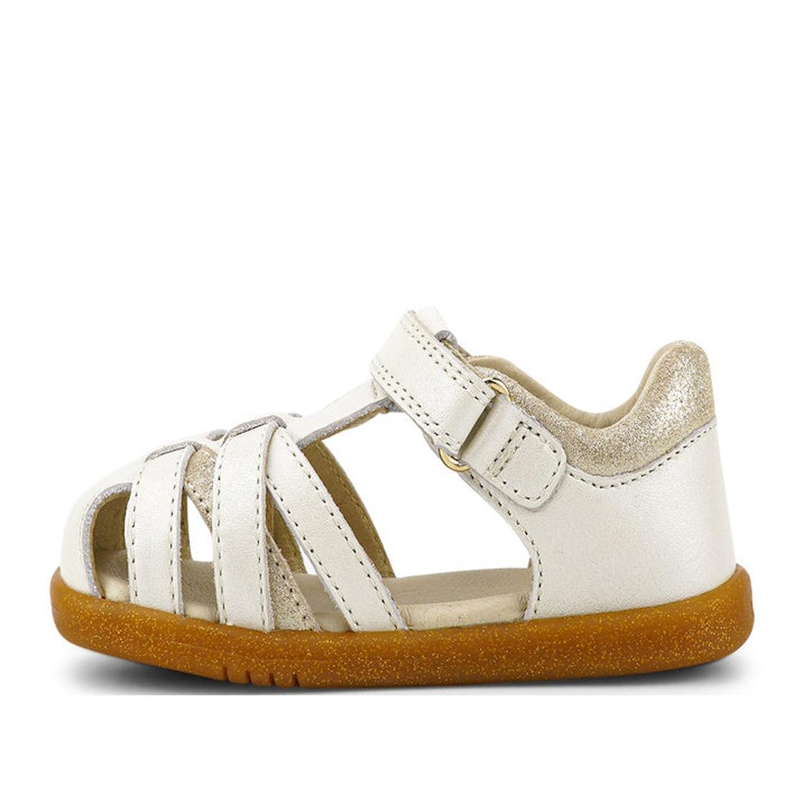 The Bobux iwalk Cross Jump Sandal Moon Pearl Closed Toe 636708 is a small kids' sandal in white leather with a closed heel, open toe, multiple straps, hook-and-loop closure, brown rubber sole, and a gold shimmer on the heel., 9420068516335, 9420068516342,