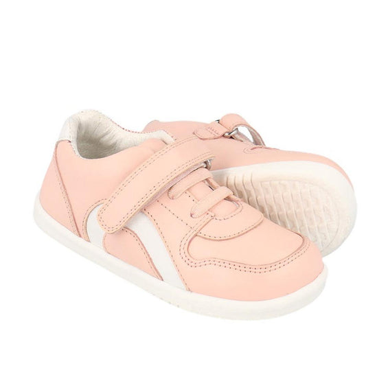 The Bobux Kids IWalk IW Comet Sneaker in Seashell Pink/White features a retro-inspired leather upper, white soles and accents, plus a Velcro strap, all showcased against a white background.