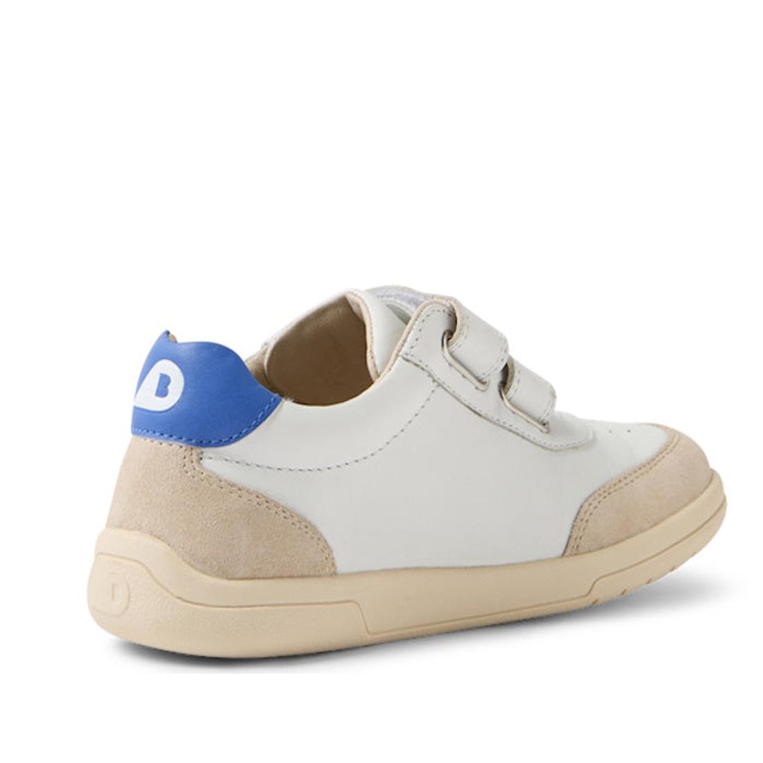 The Bobux KP Kids Plus Champ II Sneaker White Blue Juniors features a white and beige leather design, blue heel accent, adjustable Velcro straps, and a durable beige sole, shown from the back., 9420074829924, 9420074829931, 9420074829948, 9420074829955, 9