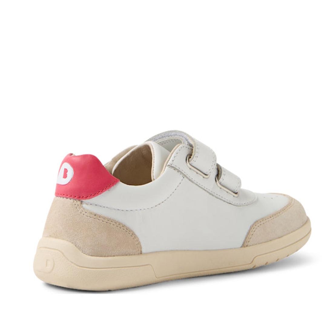 The Bobux KP Kids Plus Champ II Sneaker White Raspberry Juniors is a white and beige leather kids’ sneaker with tan flexible sole, beige suede accents, two Velcro straps, and a bright pink heel section featuring a white “B.” Back and side are shown., 9420