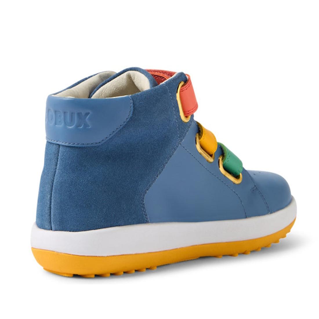 The Bobux KP Kids Plus Juniors Gamepoint Leather Boot in Coronet Blue features colorful adjustable straps, a white sole, and a yellow rubber outsole. BOBUX is embossed on the heel. The boot is shown from a rear side angle., 9420074815477, 9420074815484, 9